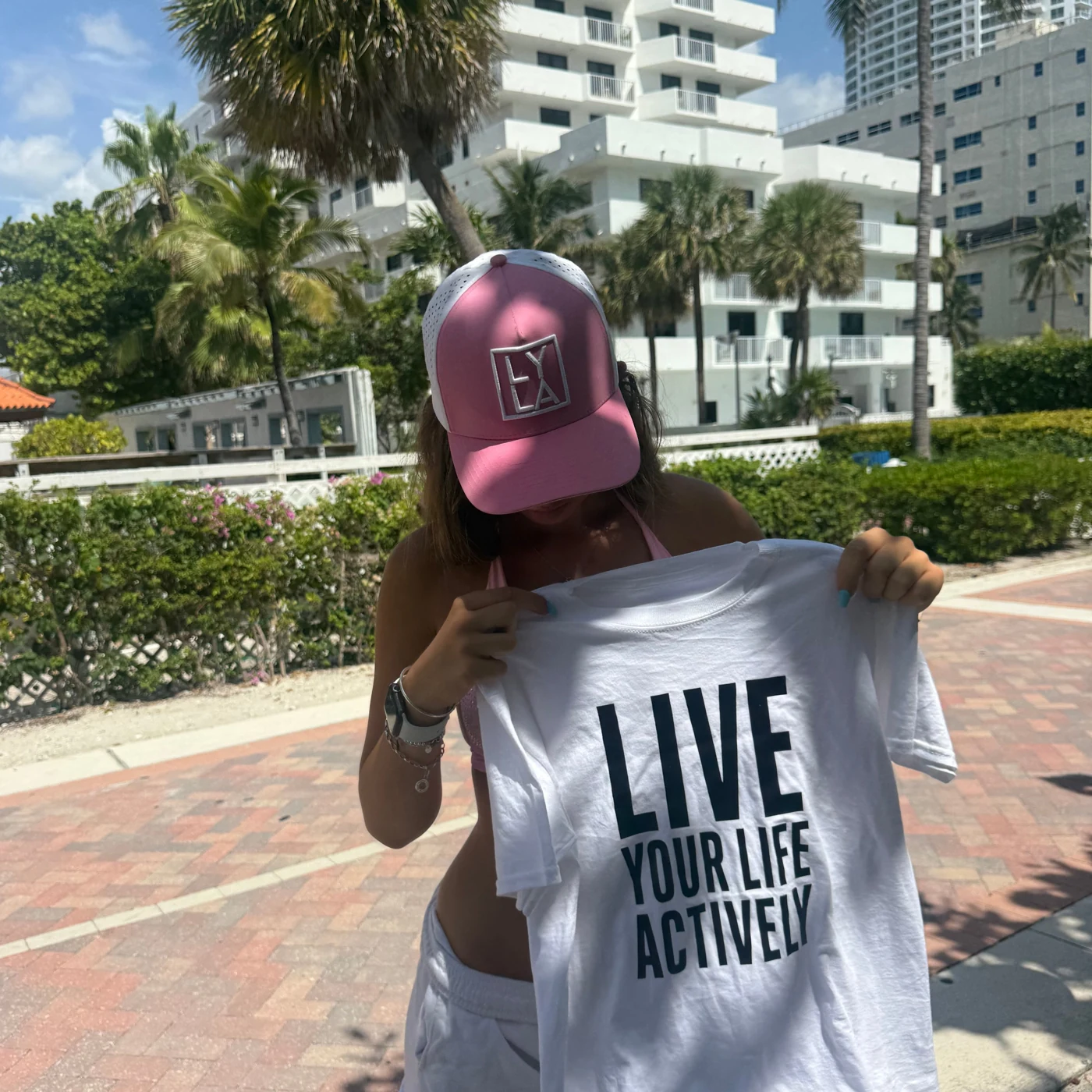 A Strawberry Ice cap and the Lyla message on a palm-lined Miami street