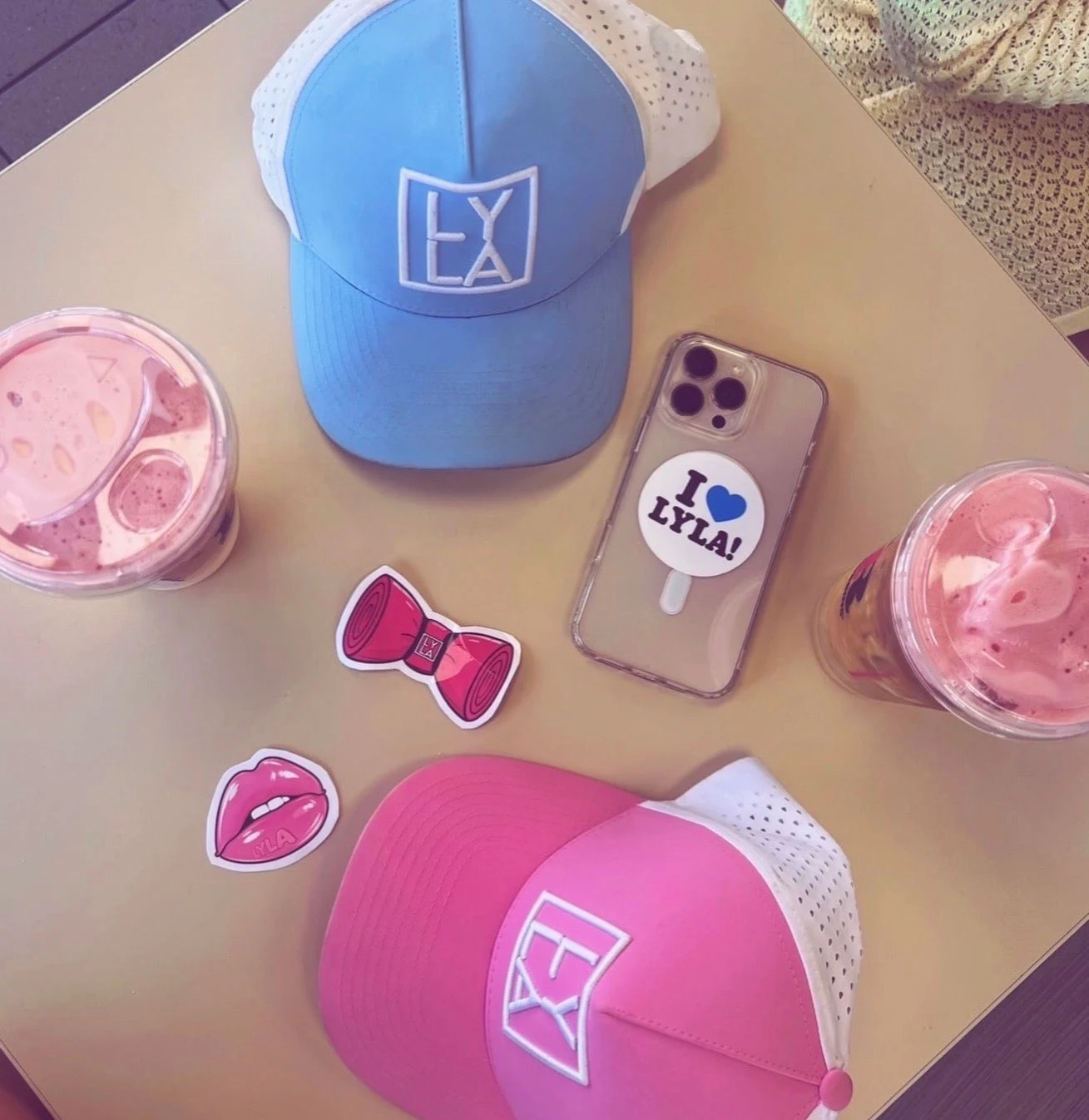 Lyla's pink and blue caps with everyday essentials and iced drinks